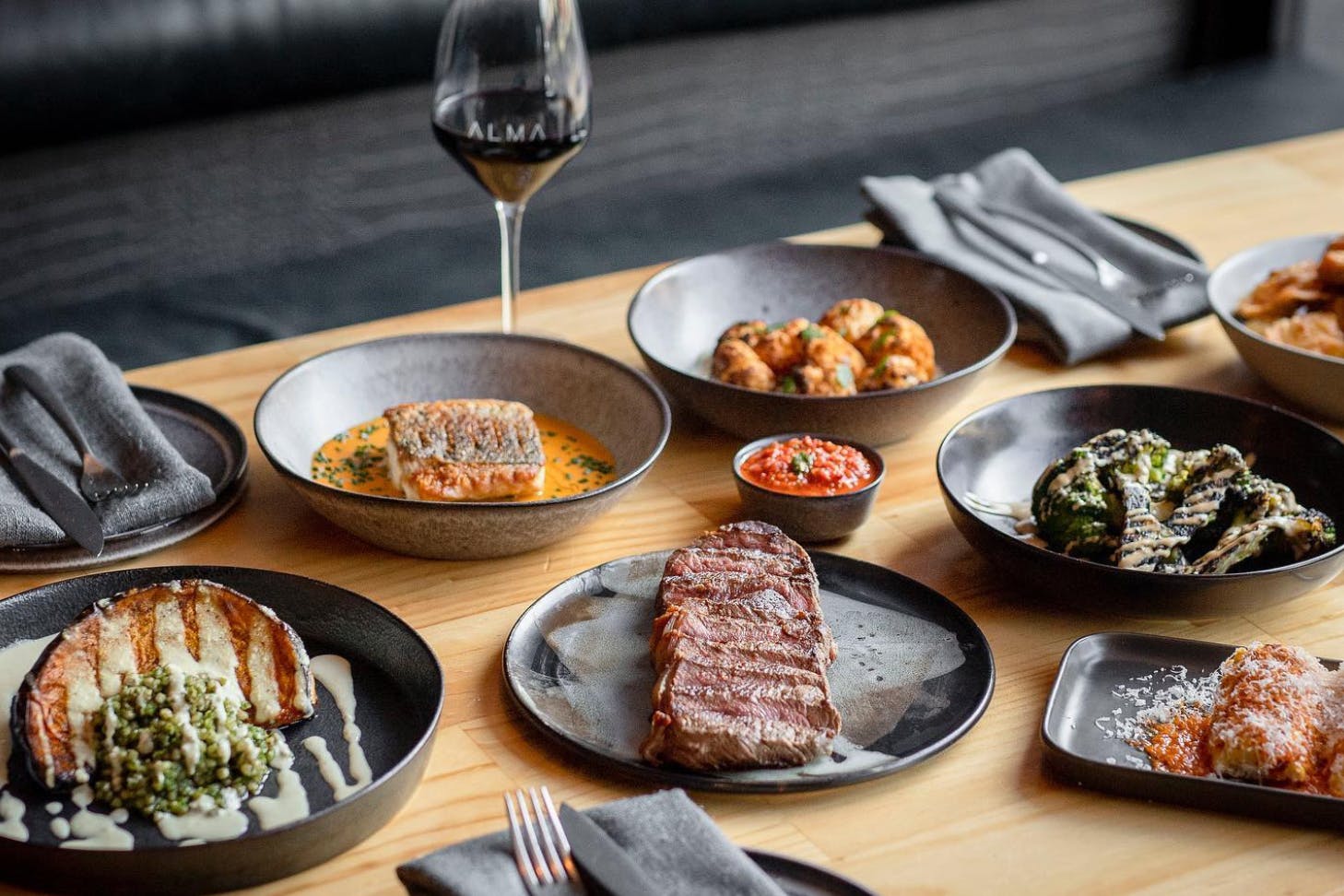 Table covered in plates of delcious food at Alma Restaurant in Geelong